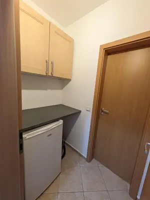 a small kitchen with a counter and a door at Bansko holiday apartments - Mountain View Resort in Bansko