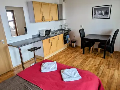 a room with a kitchen and a table and a bed at Bansko holiday apartments - Mountain View Resort in Bansko