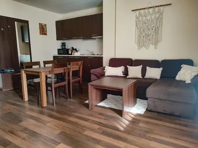 a living room with a couch and a table at Aspen Apartment A409 3OOm from Gondola in Bansko