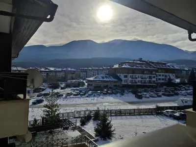 a view of a city with snow covered buildings and mountains at Aspen Apartment A409 3OOm from Gondola in Bansko