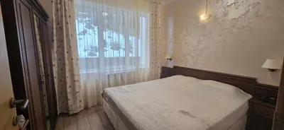 a small bedroom with a bed and a window at Forest Dreams in Pamporovo