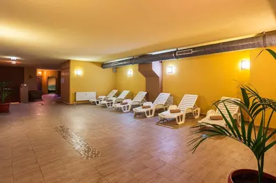 a waiting room with white chairs and a bunch of plants at Forest Dreams in Pamporovo