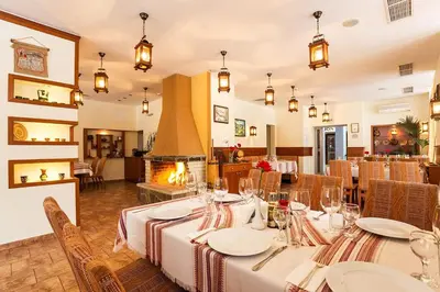 a dining room with a table and a fireplace at Forest Dreams in Pamporovo
