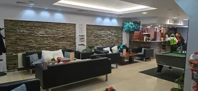 a lobby with couches and a tv in a room at Forest Dreams in Pamporovo