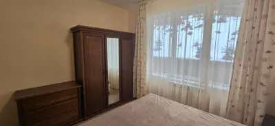 a bedroom with a bed and a dresser and a window at Forest Dreams in Pamporovo