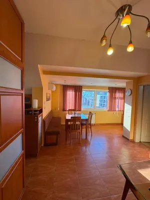 a kitchen and dining room with a table and chairs at Mall Bulgaria Apartment in Sofia