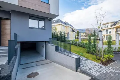 a white house with a walkway in front of it at Luxurious House in an Exclusive Complex, Mount View in Sofia