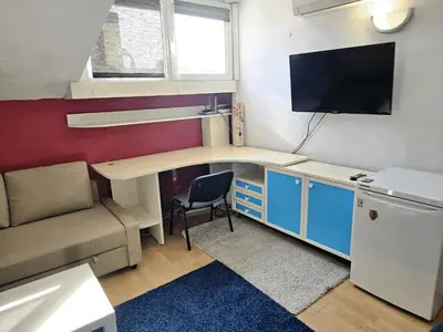 a small room with a desk and a tv at The Little Pearl of Sofia in Sofia