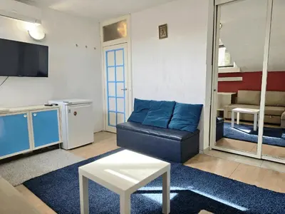 a living room with a couch and a tv at The Little Pearl of Sofia in Sofia