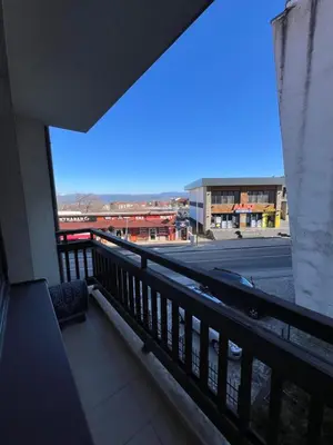 a balcony with a view of a city street at Edelweiss Apartment in Bansko