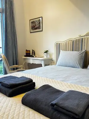 a bedroom with a bed with two towels on it at Christine's Apartment in Sofia