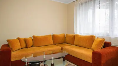 a living room with a couch and a glass table at Penthouse Astralis - Pamporovo in Pamporovo