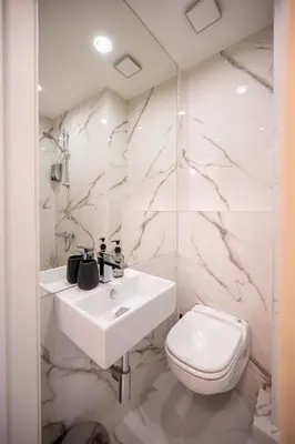 a white bathroom with a sink and a toilet at Luxury Studios in Top Center in Sofia