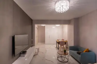 a living room with a couch and a tv and a table at Luxury Studios in Top Center in Sofia