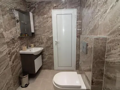 a bathroom with a toilet and a sink at MezonetCentre in Sofia