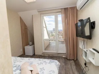 a hotel room with a bed and a large window at MezonetCentre in Sofia