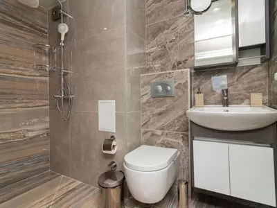 a bathroom with a toilet and a sink at MezonetCentre in Sofia