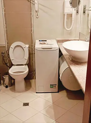 a bathroom with a toilet and a sink at Downtown Resort Bansko- Eliko Suite in Bansko