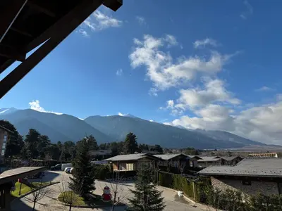 a view of a village with mountains in the background at Pirin Golf SP Apartments in Razlog