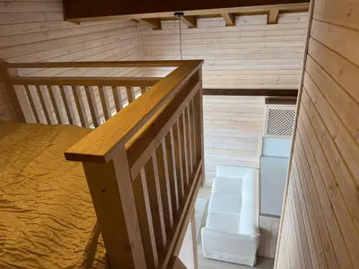 a small room with a bed and a chair at Pirin Golf SP Apartments in Razlog