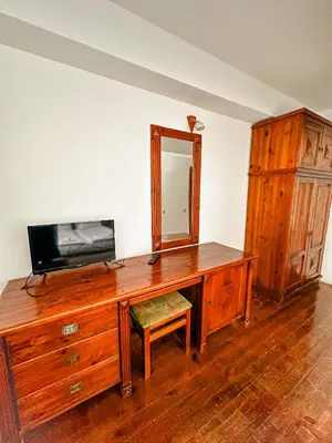 a wooden desk with a mirror and a dresser at Banderitsa Hotel and Casino in Bansko