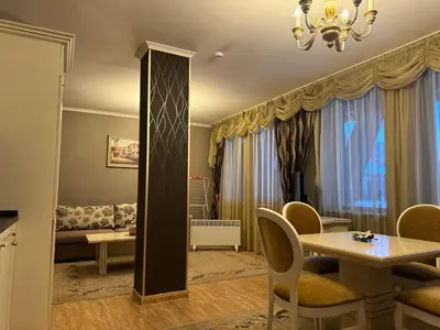 a living room with a table and chairs and a couch at Pamporovo Grand Monastery Apartment in Pamporovo