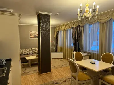 a living room with a table and a dining room at Pamporovo Grand Monastery Apartment in Pamporovo