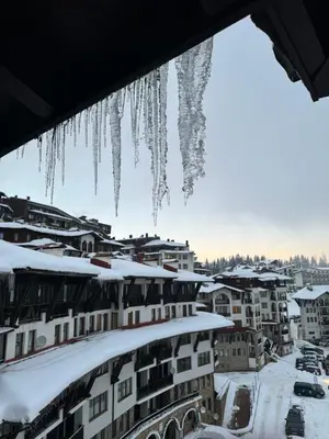 a city covered in icicles in the snow at Pamporovo Grand Monastery Apartment in Pamporovo