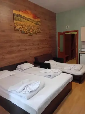 a room with three beds and a painting on the wall at STUDIO B&K in FLORA BOROVETS in Borovets
