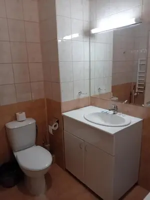 a bathroom with a toilet and a sink and a mirror at STUDIO B&K in FLORA BOROVETS in Borovets