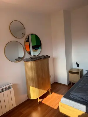 a bedroom with a dresser with two mirrors on the wall at Belvedere private apartment 1-bedroom with balcony in Bansko