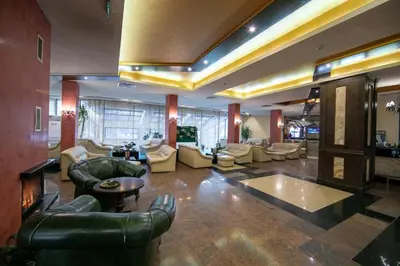a large living room with couches and chairs in a building at Ski Studio Hotel Iceberg in Borovets