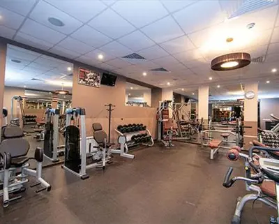 a gym with several treadmills and machines at Ski Studio Hotel Iceberg in Borovets