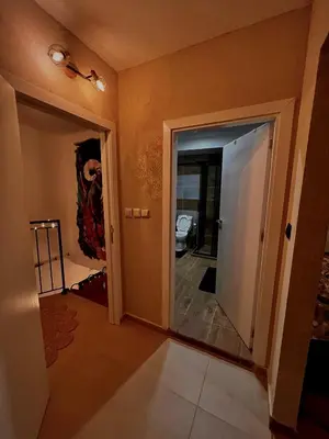 a hallway with a door leading into a room at CozyHomes in Bansko