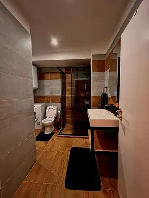 a bathroom with a toilet and a sink at CozyHomes in Bansko