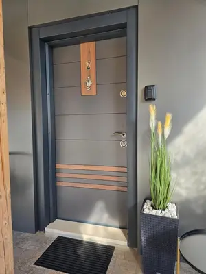 a front door of a house with a potted plant at Луксозни делукс стаи Мечката in Botevgrad