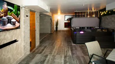 a room with a hallway with a table at Семеен хотел БОНЖУР in Panagyurishte