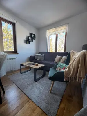 a living room with a blue couch and a table at Mountain view Lux Apartment in Bansko