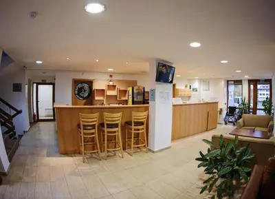 a lobby with a bar with stools at Mountain view Lux Apartment in Bansko