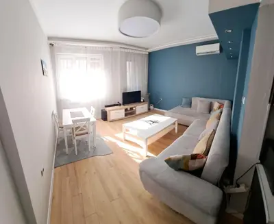 a living room with a couch and a table at Apartment Sofia top center in Sofia