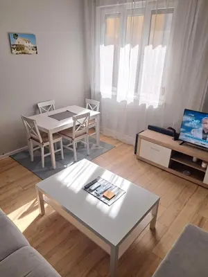 a living room with a table and a white table and chairs at Apartment Sofia top center in Sofia