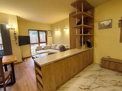 a living room with a counter and a couch at Woodsy views 1 bedroom apartment in Bansko