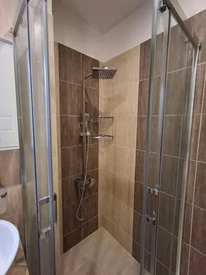 a shower with a glass door in a bathroom at Woodsy views 1 bedroom apartment in Bansko