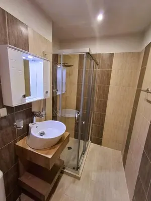 a bathroom with a sink and a shower at Woodsy views 1 bedroom apartment in Bansko