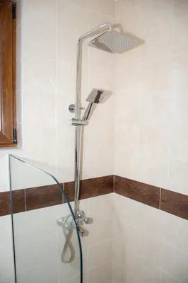 a shower with a shower head in a bathroom at Орбелус in Bansko