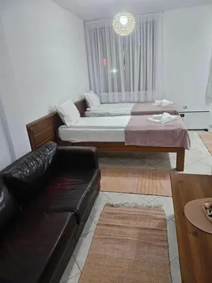 a living room with a couch and a bed at Gondola Peak Apartment in Bansko
