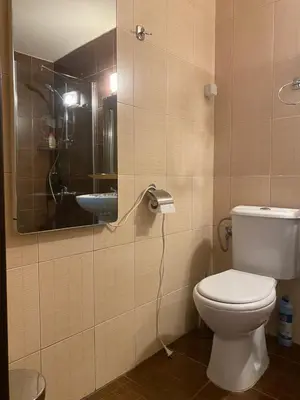 a bathroom with a toilet and a mirror and a sink at Royal Towers Bansko Apartment - Gondola in Bansko