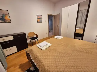 a bedroom with a bed with two towels on it at Botev's Finest 3BR in Sofia