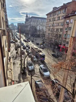 a city street with cars parked in a parking lot at Botev's Finest 3BR in Sofia