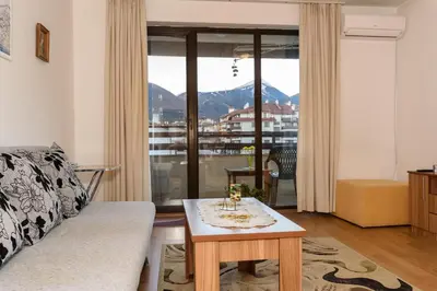 a living room with a couch and a table at Niki's cosy place in Bansko
